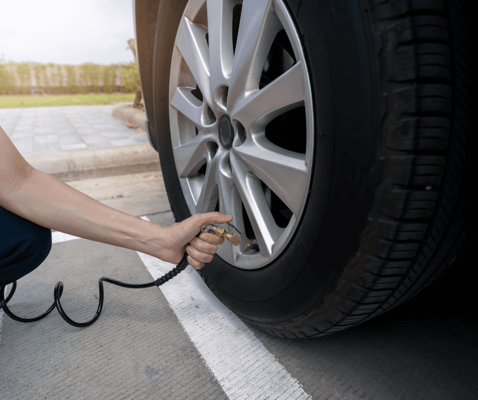 Person checking tire pressure