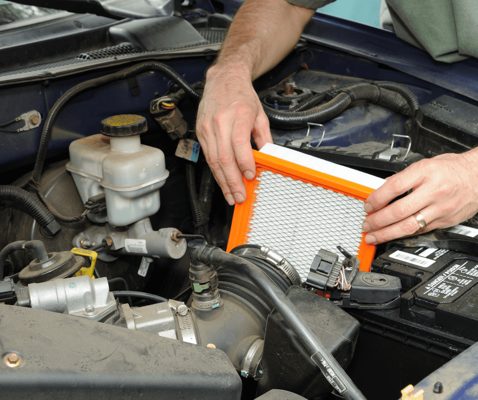 person changing the car air filter
